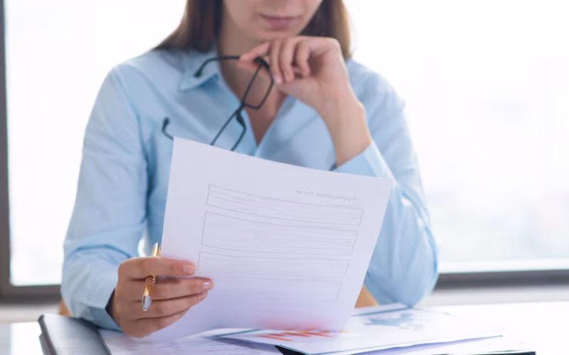 closeup-woman-holding-reading-document_1262-16067