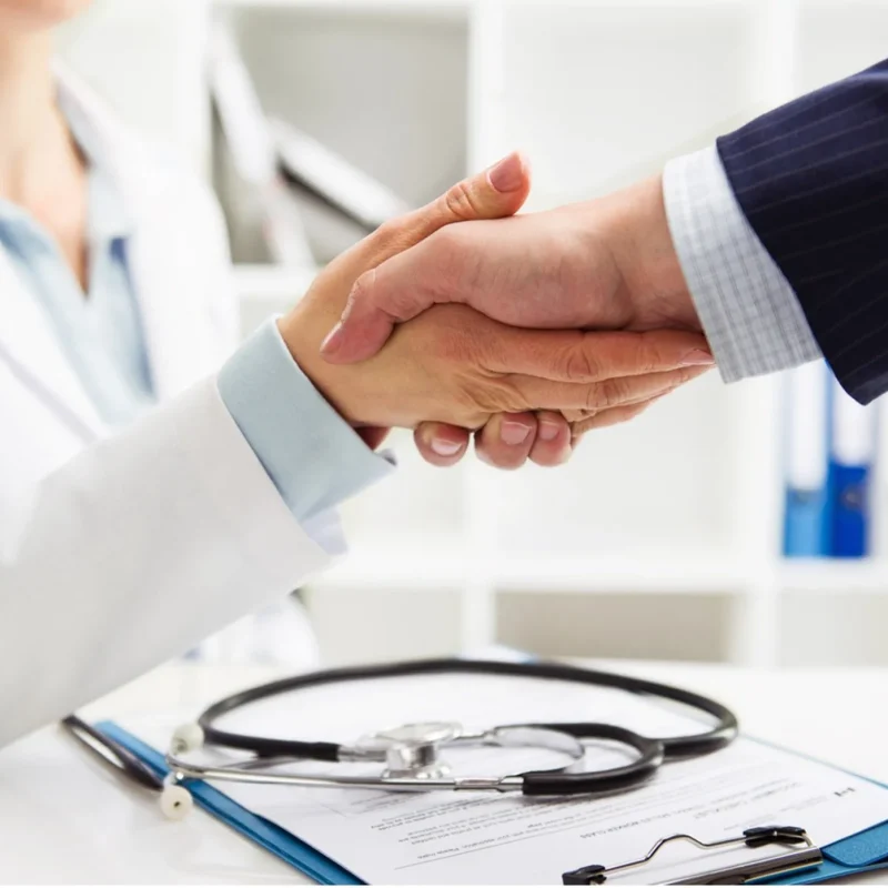 doctor-shaking-hands-with-newly-hired-physician-employment-contract-concept